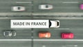 Aerial overhead view of semi-trailer truck with MADE IN FRANCE text driving along the road. French business related 3D