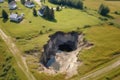 top-down view of a sinkhole in a remote rural setting