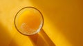 Top-down view of a spinning glass of orange juice with copy space