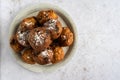 Top down view of a stack of oliebollen (Dutch dough fritters) with a glass of champagne on white background with