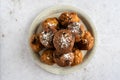 Top down view of a stack of oliebollen (Dutch dough fritters) with a glass of champagne on white background with