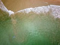 Top down view of surfers waiting for waves off a tropical beach Royalty Free Stock Photo