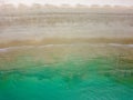 Top down view of surfers waiting for waves off a tropical beach Royalty Free Stock Photo