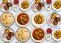 A Delicious Assortment of Indian Food Dishes Served on White Plates Royalty Free Stock Photo