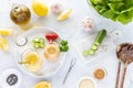 Top down view of a tray with bottles of homemade salad dressing, surrounded by fresh ingredients. Royalty Free Stock Photo