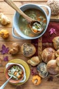 Top down view of turkey soup with a variety of buns scattered all around. Royalty Free Stock Photo