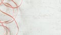 Top down view - two wires red and transparent copper speaker cable on white stone board desk, wide banner with space for Royalty Free Stock Photo