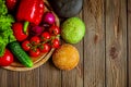 Top view of variety of three hamburger buns with vegetables. Black, green, yellow buns. Copy Space