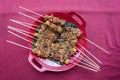 Top down view of vegetarian sate with tofu and tempeh covered in a peanut sauce