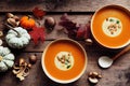 Top down view of warm autumn pumpkin soup in two bowls.