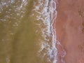 Top down view of waves breaking in the sand, flying over tropical sandy beach and waves Royalty Free Stock Photo