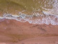 Top down view of waves breaking in the sand, flying over tropical sandy beach and waves Royalty Free Stock Photo