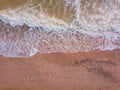 Top down view of waves breaking in the sand, flying over tropical sandy beach and waves Royalty Free Stock Photo