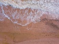 Top down view of waves breaking in the sand, flying over tropical sandy beach and waves Royalty Free Stock Photo