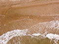 Top down view of waves breaking in the sand, flying over tropical sandy beach and waves Royalty Free Stock Photo