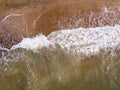 Top down view of waves breaking in the sand, flying over tropical sandy beach and waves Royalty Free Stock Photo