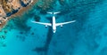 Top down view of white plane flying over blue sea, ocean, travel, vacation concept - AI generated image Royalty Free Stock Photo