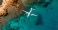 Top down view of white plane flying over blue sea, ocean, travel, vacation concept - AI generated image Royalty Free Stock Photo