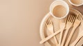 Eco-friendly disposable wooden forks on paper plate. Minimalist style image. Sustainable tableware for environmentally