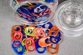 Top down wide view of a jar of multi colored can pull tabs laying on it`s side and some lying loose Royalty Free Stock Photo