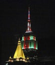 Top of the Empire State Building in Red and Green and Chrysler building in gold at night Royalty Free Stock Photo