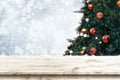 Top of empty wood table with beautiful Christmas tree and snowfall Royalty Free Stock Photo