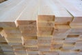 Top-end view of stack of three-layer wooden glued laminated timber beams from pine finger joint spliced boards