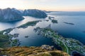 From top of the famous Reinebringen overlooking the city of Reine in Lofoten,Norway during the midnight sun. Royalty Free Stock Photo