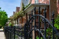 Top of a Fancy Black Metal Fence in front of a Row of Old Homes in Logan Square Chicago Royalty Free Stock Photo