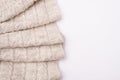 Top flatlay close up view photo of folded knitted textile lying on white background with blank empty space