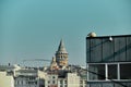 Top of the galata tower early in morning from galata bridge behind the fishing rods. Royalty Free Stock Photo