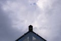 Triangular roof on the sky background