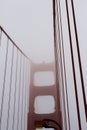 The top half of the tower and cables of the Golden Gate Bridge shrouded in fog, San Francisco, California Royalty Free Stock Photo