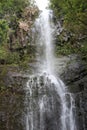 The top half of Wailua Falls plummeting down a rocky cliff surrounded by lush vegetation in Hana, Maui Royalty Free Stock Photo