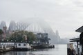 The top of the Harbour Bridge was covered by heavy mist fog in the morning, from Circular Quay view point, Sydney. Australia: 08/ Royalty Free Stock Photo