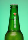 the top of a heineken beer bottle on a green glowing background Royalty Free Stock Photo