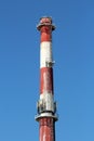 Top of high industrial red and white chimney with multiple cell phone antennas Royalty Free Stock Photo