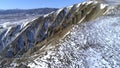 Top of High mountains, covered by snow. Shot. Top view of the snowy hill. Beautiful landscape Royalty Free Stock Photo