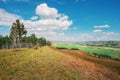 From the top of the hill, a view of the distant mountains of the fields and the edges of trees Royalty Free Stock Photo