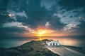 view from a rock on the typical greek church Chapel of Agios Nikolaos on zakyntos, sunrise at the sea Royalty Free Stock Photo