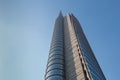 The top of a huge multi-story modern office building against a blue sky. 01.2020 Milan Royalty Free Stock Photo