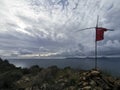 Top of the Kizil Ada island. Top of a mountain with a cross and a T-shirt on it.