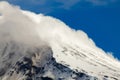 Top of the Lanin Volcano from Lake Tromen in Neuquen, Argentina. This volcano is covered by eternal snow and with some clouds that Royalty Free Stock Photo