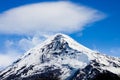 Top of the Lanin Volcano from Lake Tromen in Neuquen, Argentina. This volcano is covered by eternal snow and with some clouds that Royalty Free Stock Photo