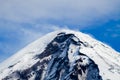 Top of the Lanin Volcano from Lake Tromen in Neuquen, Argentina. This volcano is covered by eternal snow and with some clouds that Royalty Free Stock Photo