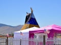 Top of large teepee towers at an outdoor festival Royalty Free Stock Photo