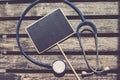 Top lay, signage and stethoscope on wooden desk background