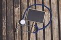 Top lay, signage and stethoscope on wooden desk background