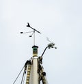 Windex, lanterns and radar reflectors at the top of a mast Royalty Free Stock Photo