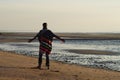 Top model in poncho on the beach Royalty Free Stock Photo